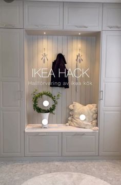 the front window of ikea haok's new store, featuring white cabinets and wreaths