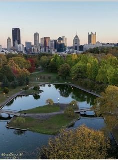 an aerial view of the city skyline and river in fall time with trees around it