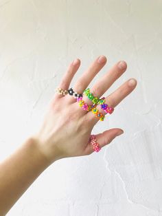 These rings are stretchy and can fit many sizes of fingers. Choose one of the color combinations or make your own! || Details || Seed Bead Flower Ring, Seed Bead Flower, Summer Choker, Stretchy Rings, Seed Bead Flowers, Bead Flower, Stretch Ring, Wristlet Keychain, Daisy Chain