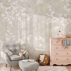 a chair and ottoman in a room with flowers on the wall behind it, next to a chest of drawers