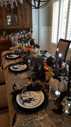 a dining room table set for halloween dinner