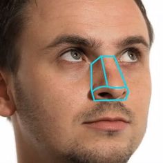 a man with a blue line drawn on his nose to show the shape of a cube