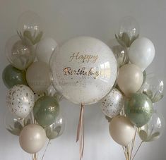 balloons and confetti are arranged in the shape of a happy birthday balloon