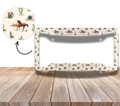 an image of a horse and cactus pattern on a license plate frame with a white background