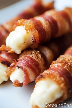 bacon wrapped in cheese on a white plate