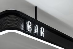 a bar sign hanging from the ceiling