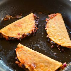 some food is cooking in a skillet on the stove and ready to be eaten