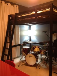 a bedroom with a bunk bed and drum set