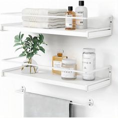 two white shelves with towels, soaps and other bathroom items on top of them