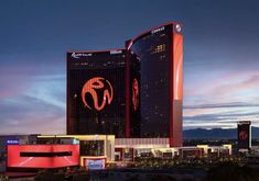 the las vegas hotel and casino is lit up at night with neon lights on it