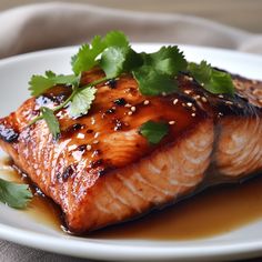 salmon with sesame seeds and cilantro on a white plate