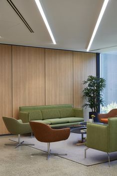 a living room filled with lots of green furniture