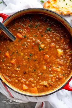 a red pot filled with beans and bread