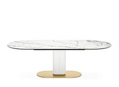 an oval marble dining table with gold pedestals and a white glass top, viewed from the front