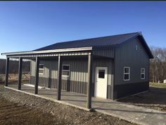 a metal building with two doors on the front and one door open to let in light