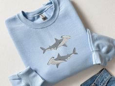 Embroidered Hammerhead Shark Sweatshirt, Funny Hammerhead Shark Shirt, Hammered Sweatshirt, Shark Shirt, Marine Ocean Shirt, Gift for Her, CozyGenZ This Cute & Funny Embroidered Hammerhead Shark Sweatshirt is a great adition to your all season wardrobe. Whether you're running errands, taking a walk outside, or staying cozy at home, this unisex sweatshirt is perfect for you! Our crewnecks are made from the highest quality fabric for an incredibly soft and comfortable fit, with advanced printing t Marine Biology Shirts, Ocean Sweatshirt, Shark Sweatshirt, Ocean Shirt, Shark Gifts, Shark Lover, Shark Shirt, Hammerhead Shark, Animal Sweatshirt