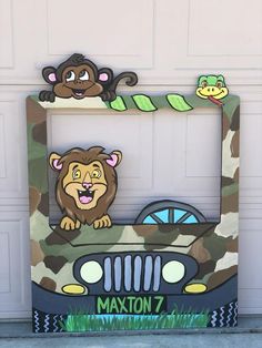 a car with a lion and monkey painted on the front, sitting in front of a garage door