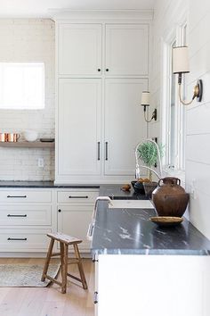 the kitchen is clean and ready for us to use it's white cabinetry