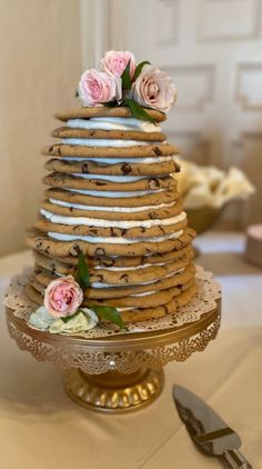 there is a cake made out of cookies and flowers on the table with utensils