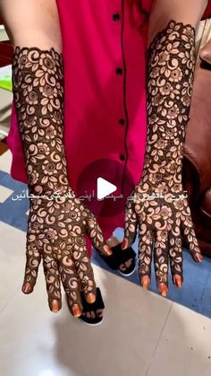 a woman with her hands covered in henna