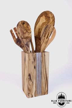 wooden utensils and spoons are in a wood block holder on a white background