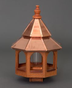 a wooden lantern with a glass dome on top