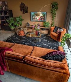 a living room filled with furniture and plants