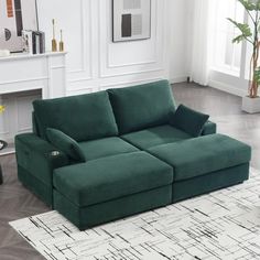 a green couch sitting on top of a white rug