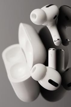 an array of earbuds sitting on top of each other in front of a gray background