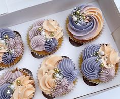 six cupcakes in a box decorated with flowers and pearls