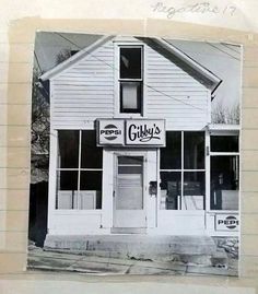 a black and white photo of a restaurant called gilly's on the corner