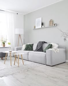 a living room filled with furniture and white walls