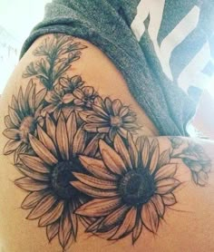 a woman's thigh with sunflowers on it