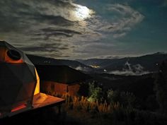 the night sky is full of clouds and stars as seen from a tent in the mountains