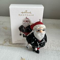 a christmas ornament in the shape of santa claus and an evil looking man