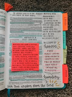 an open bible with sticky notes on the pages and colored markers attached to each page