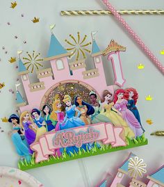 there is a birthday card with princesses in front of it and confetti on the table