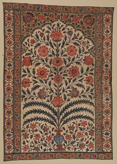 an old rug with flowers and leaves on the bottom, surrounded by other decorative elements