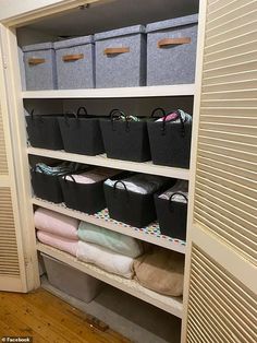 an organized closet with baskets and blankets