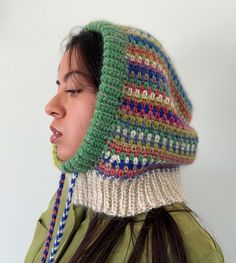 a woman wearing a multicolored knitted hat