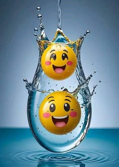 two yellow smiley faces are splashing in the water with their mouths open and eyes closed