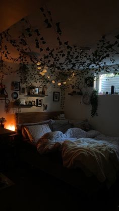 an unmade bed in a dimly lit room with lots of birds flying above it