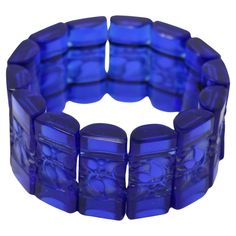 Rene Lalique blue glass 'Ceriser' Bracelet. The bracelet consists of 14 rectangular, cylinder-half shaped tablets, strung together with elastic. Ceriser is french for cherry tree and each tablet has molded leaf and berry decoration. Engraved makers mark, 'R Lalique France' to the side of one tablet. Book reference: 'R. LALIQUE Catalogue Raisonné De L'Oeuvre De Verre', by Felix Marcilhac. Les Editions De L'Amateur. Figure 1329. Size - my wrist is 19cm (7.5ins) diameter and I was able to wear. Ple Colour Drenching, Monochromatic Scheme, Ribbon Chair, Lalique Jewelry, Tangerine Quartz, Book Reference, Blue Clothes, Pierre Paulin, Rene Lalique