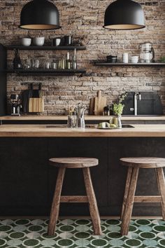 two wooden stools sit in front of an island