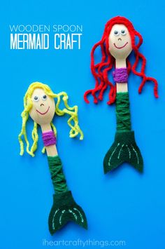 two little mermaids made out of yarn sitting next to each other on a blue background