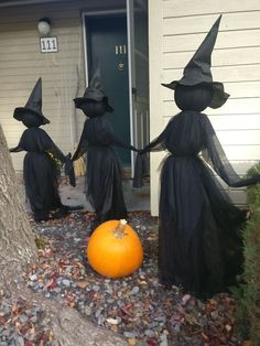 three witches holding hands in front of a house