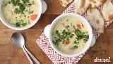 two bowls of soup with pita bread on the side