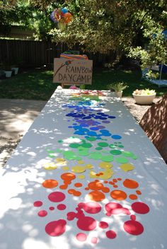 a long table covered in lots of different colored confetti on top of it