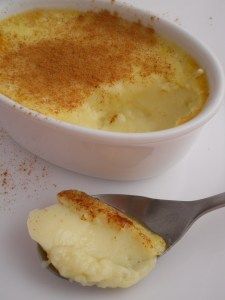 a bowl of food with a spoon next to it