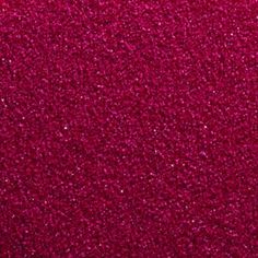 a close up view of a red carpet with lots of small speckles on it